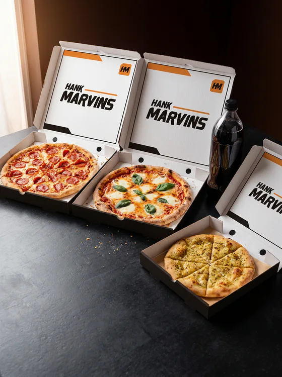 Two 12" pizzas, served in Hank Marvins packaging